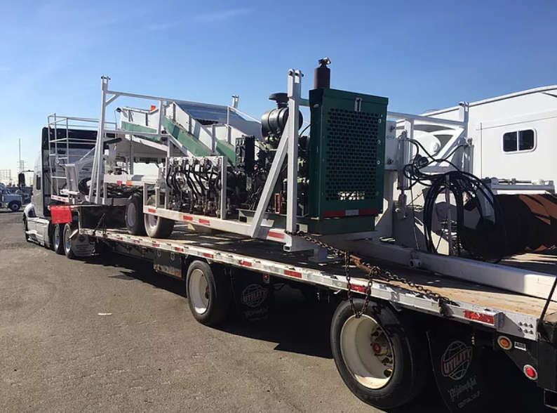 Agricultural equipment on flatbed trailer